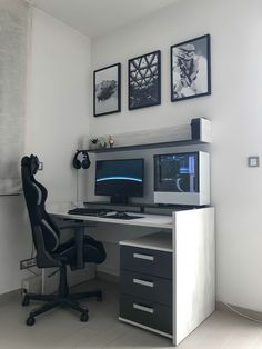 a computer desk with two monitors and a chair in front of the monitor on it