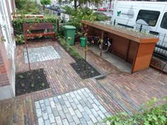 a small garden area in front of a white van