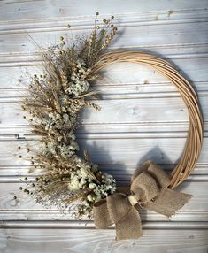 a wreath with dried flowers and burlap bow