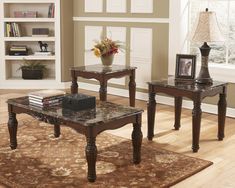 a living room with two tables and a rug on the floor