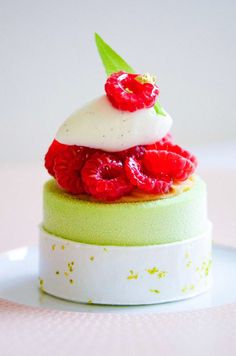 a close up of a pastry with raspberries on top