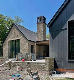 a house with a clock tower in the back yard and other items on the ground