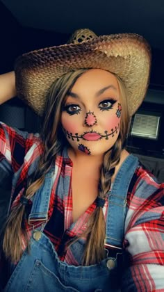 a woman with makeup is wearing a cowboy hat