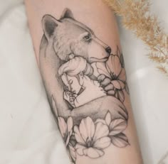 a woman's leg with a bear and flowers on it