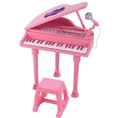 a pink toy piano sitting next to a stool