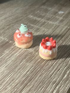 two small cakes sitting on top of a wooden table