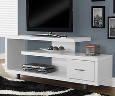 a flat screen tv sitting on top of a white entertainment center