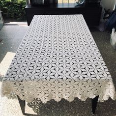 a white table cloth on top of a black dresser