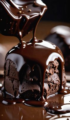 a piece of chocolate cake is being drizzled with melted chocolate