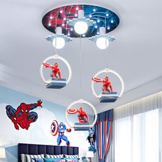 a bedroom with spiderman decorations hanging from the ceiling