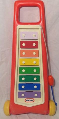 a toy musical instrument sitting on top of a white sheet