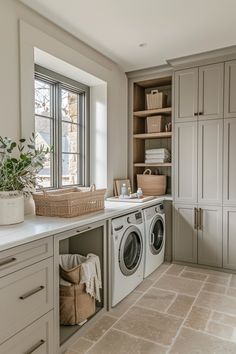 a washer and dryer sitting in a kitchen next to a window with lots of storage