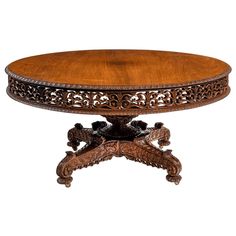 an ornately carved table with wooden top