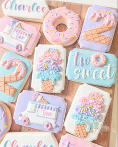 decorated cookies with ice cream and donuts are arranged on a wooden board that says, choose the sweet