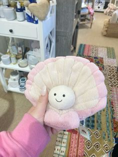 a person holding a stuffed animal in their hand