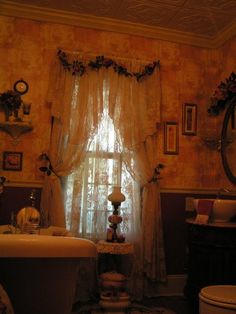 an old fashioned bathroom is decorated with vintage decor and antique items, including a tub