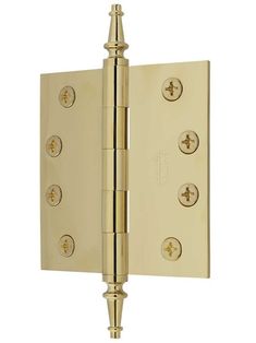 a brass plated door hinge with four screws