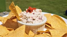 a white plate topped with chips and salsa