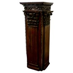 a tall wooden cabinet with carvings on the top and bottom part, sitting in front of a white background