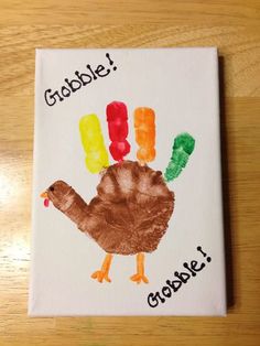 a handprinted turkey on a white canvas with words gobble croise