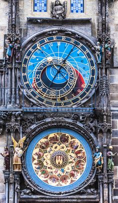 two large clocks on the side of a building