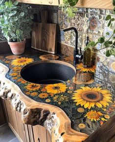 a kitchen with sunflowers painted on the counter top and wooden sink faucet