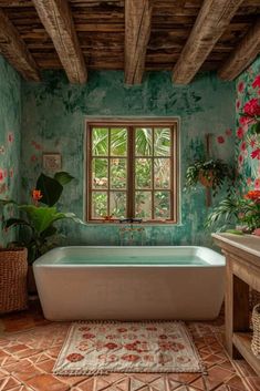 a bath tub sitting under a window next to a sink and a rug on the floor