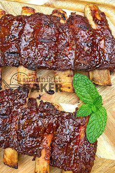 barbecue ribs on a cutting board with mint leaves