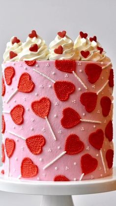 a pink and red cake with hearts on it