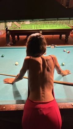 a person standing in front of a pool table