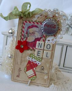 a christmas card with santa clause on it and buttons attached to the front, sitting on a lace doily