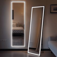 a large mirror sitting in the middle of a room next to a couch and bed