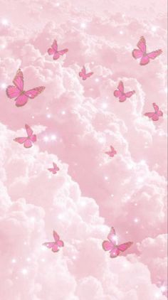 there are many pink butterflies flying in the sky above some fluffy white clouds and stars