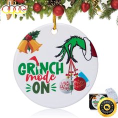 a christmas ornament hanging from a tree with ornaments around it and the words grin made on