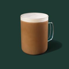 a glass mug with a white lid on a dark green background, filled with liquid