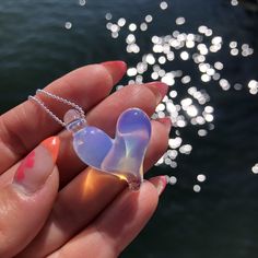 "One of a kind ocean inspired borosilicate glass heart necklace in a gorgeous Ghost slightly transparent and iridescent colour. Definitely the most versatile wearable piece in the glasea collection. The colour sparkles even more with brighter colours. Approximately 1\" x 1\" Pendant comes with a sterling silver stamped 925, 1 mm snake or ball chain. Please select your length at check out.  Sterling Silver chains are made in Italy.  Each piece is completely handmade and is one of a kind. Therefore, sizes are approximate and design is unique and therefore might vary slightly from the photos. Thanks for supporting small! All pieces are hand made in Vancouver, BC, Canada" Handmade Iridescent Jewelry For Valentine's Day, Iridescent Glass Jewelry As Gift, Iridescent Glass Jewelry Gift, Iridescent Glass Jewelry For Gifts, Iridescent Glass Necklaces As Gifts, Unique Iridescent Glass Necklaces, Iridescent Heart Pendant Jewelry For Valentine's Day, Heart-shaped Glass Necklaces For Jewelry Making, Clear Heart Pendant Jewelry Gift