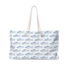 "This large beach tote bag is roomy enough to hold it all - hat, towels, sunscreen and all you need for a day at the beach.  Made from hardy poly poplin, this bag features a wide opening to easily pull things in and out, and a T-bottom so the bag sits flat when you put it down. Cotton rope handles thread through metal grommets and tied in a knot give the bag a relaxed coastal feel. The Carry All Tote features cute blue fish swimming  all over both sides of the bag. The bag fabric is white with a White Beach Bag For Vacation, Summer Large Capacity Cotton Beach Bag, Large Capacity Cotton Beach Bag For Summer, Beach Tote Weekender Bag With Large Capacity, Beach Weekender Bag With Large Capacity, Summer Beach Weekender Bag In Rectangular Shape, Large Capacity Tote Weekender Bag For Beach, Rectangular Summer Weekender Bag For Beach, Summer Rectangular Weekender Bag For Beach