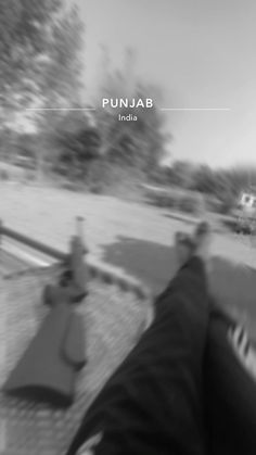 a blurry photo of people riding bikes down a street with the caption punjab india