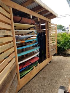 there are many surfboards in the storage area for people to use it as a place