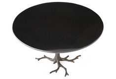 a round black table with metal branches on it