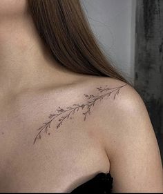 a woman with a tattoo on her shoulder