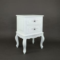 a white nightstand with two drawers on one side and an open drawer on the other