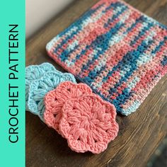 three crocheted coasters sitting on top of a wooden table