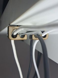 an electrical wire is connected to the wall with two white wires in front of it