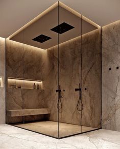 a bathroom with a walk in shower next to a sink and a mirror on the wall