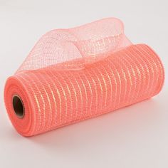 a roll of orange mesh sitting on top of a white table