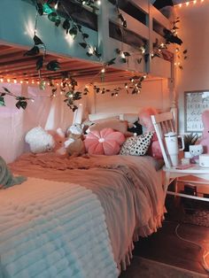 a bed with pink and white pillows on top of it