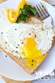 an egg is on top of bread with orange slices and parsley sprinkled around it