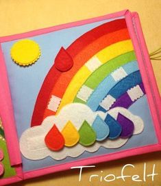 this is an image of a felt craft project with rainbows and clouds on it