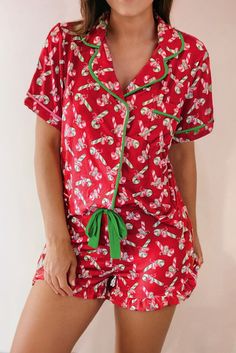 The cutest button-up pj/lounge outfit for women this season! Adorable all over candy cane print, available in red, pink, or green color. Pull-on shorts with waist tie. Button-down short sleeve top. 95% polyester 5% elastane Available in women's sizes: S-2XL (see size chart below) Brand: LA Society Good things take time. Quicker shipping: These pjs ships directly to you from our overseas warehouse, and will arrive in approximately 7-12 business days. Please note: these are a high heat item, and m Holiday Pjs, Outfit For Women, Lounge Outfit, Statement Dress, Christmas Vibes, Halloween Looks, Christmas Candy Cane, Everyday Dresses, Lounge Set